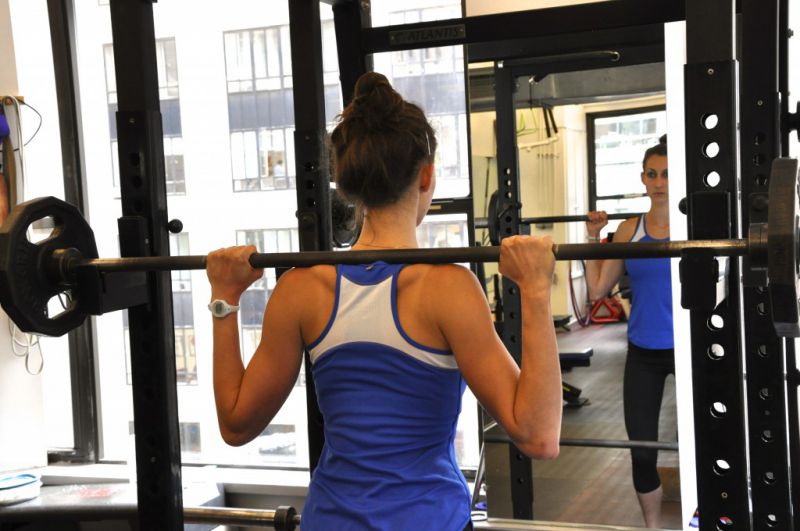 Racking the bar for back Squats - step under the bar and place it across the traps.